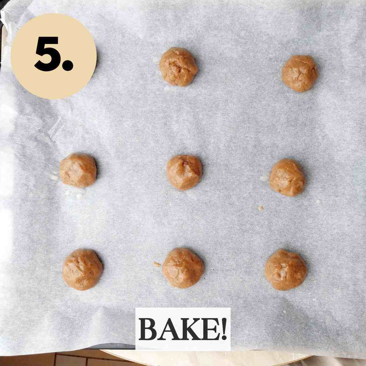 Cookie dough balls on a baking sheet lined with baking paper.